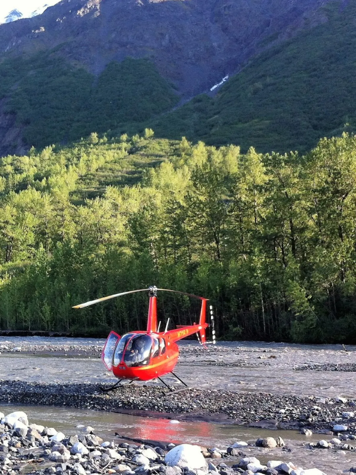 springtime in alaska with a red helicopter